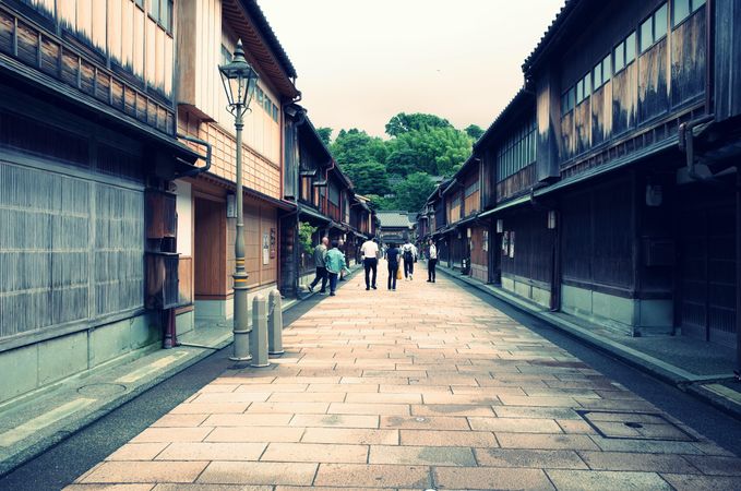 People walking in an alley between buildings