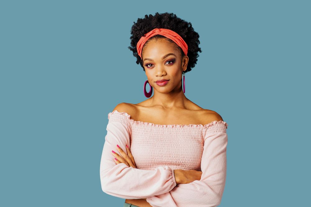 Studio shoot of confident Black woman with her arms crossed