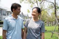 Male and female standing on walkway in residential area