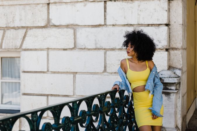 Stylish female leaning on railing outdoors