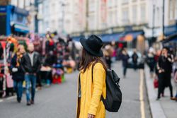 Unrecognizable tourist walking on street during festival