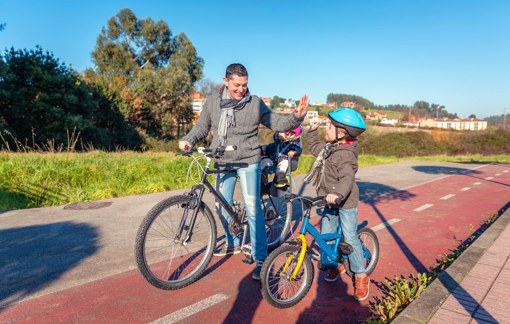 Father and son high fiving on bike ride