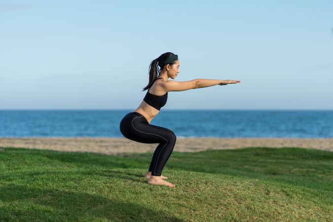 Woman doing yoga on the beach