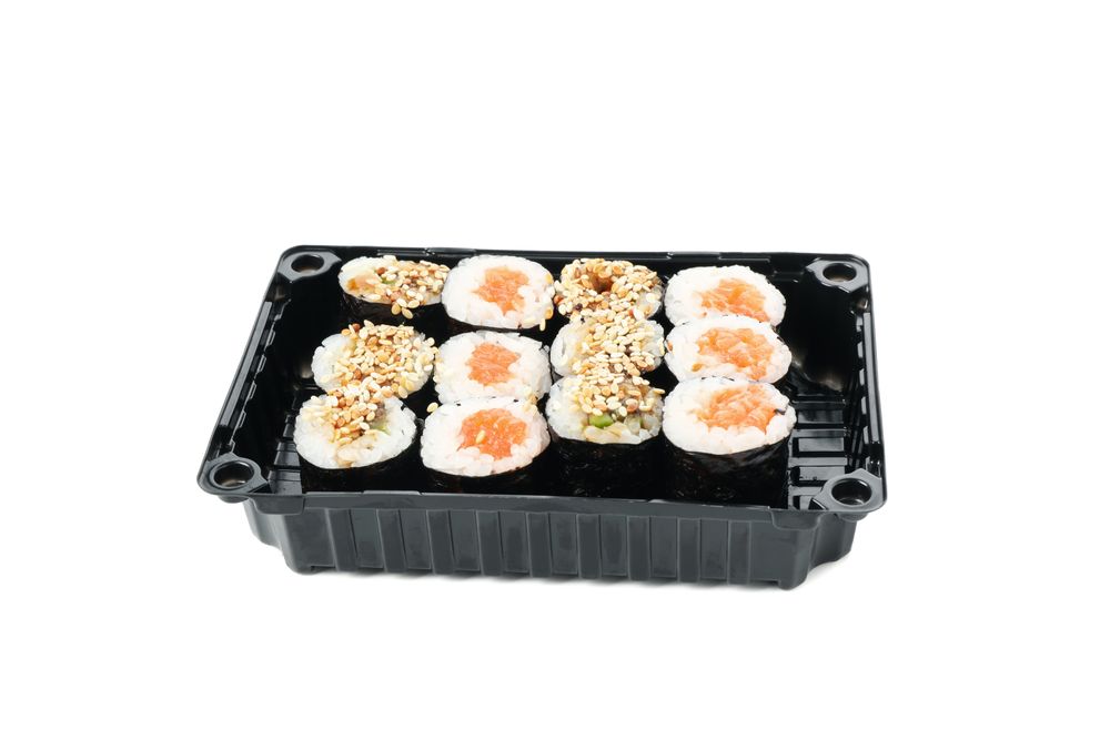 Box with sushi isolated on plain background