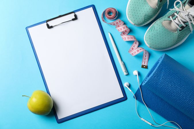 Weight loss or healthy lifestyle accessories on blue background