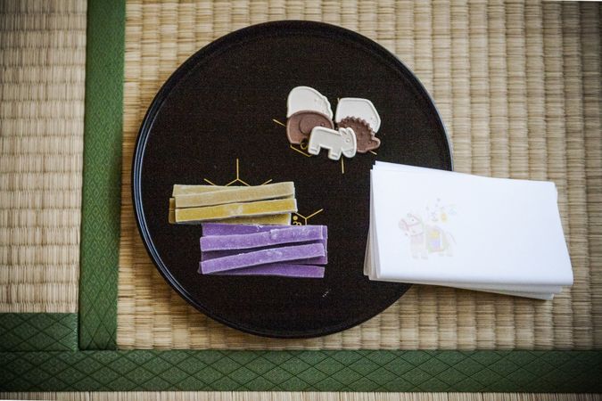 Paper tissue beside pastry on a dark plate