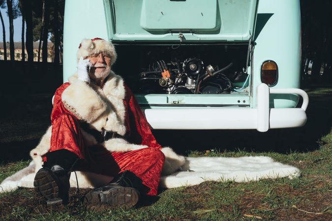 Santa Claus resting by old van