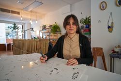 Female jeweler creating collection of accessories in workshop