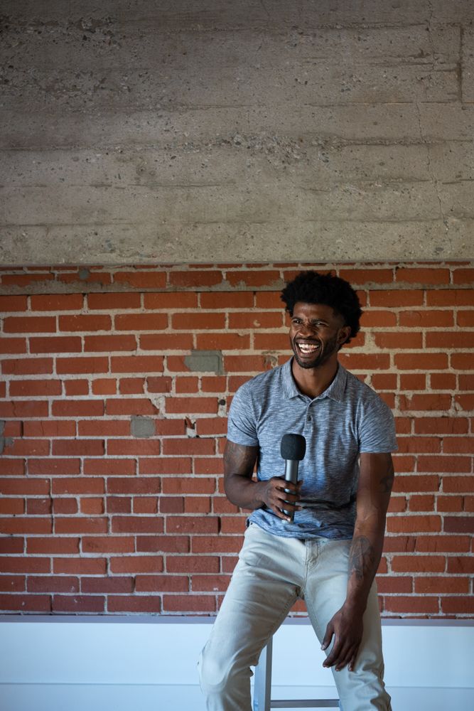 Man laughing while public speaking