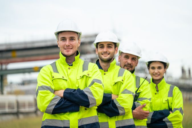 Engineer worker in arms crossed standing in a row looking smile to camera