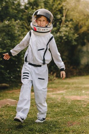 Kid playing in astronaut suit outdoors