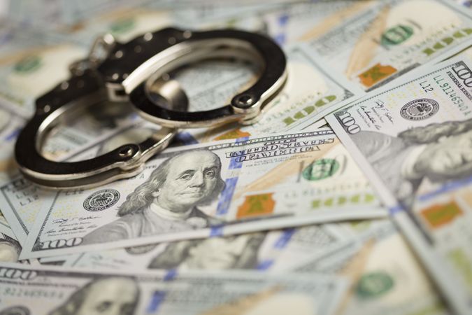 Handcuffs and Newly Designed One Hundred Dollar Bills