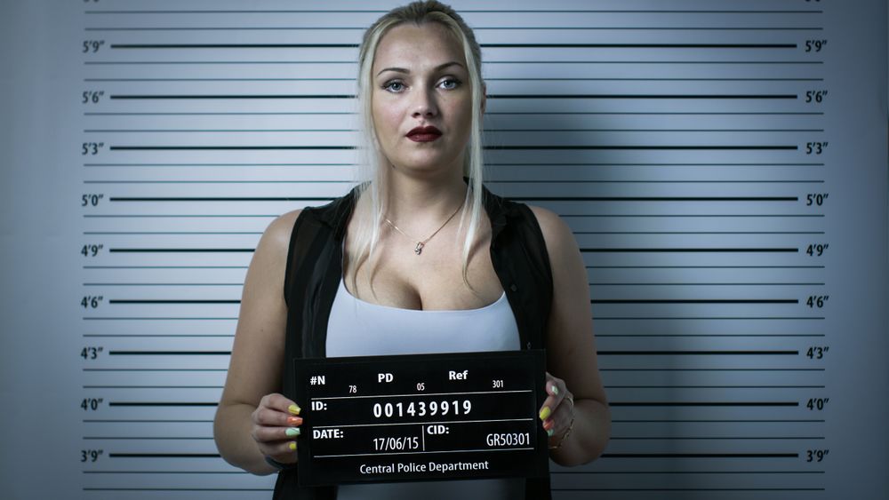 In a Police Station Arrested Woman Gets Front-View Mug Shot.