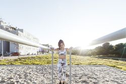Young woman training on parallel bars