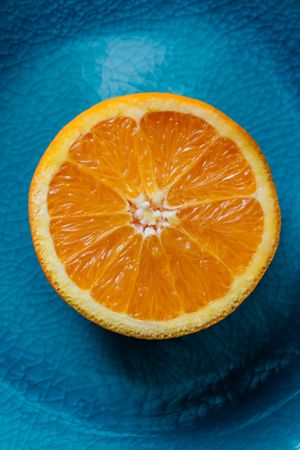 Fresh orange in a teal plate