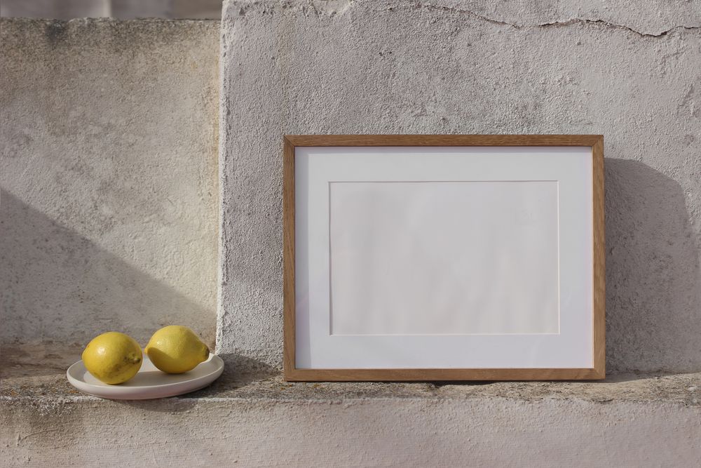 Blank horizontal wooden picture frame mockup against old textured shabby wall.