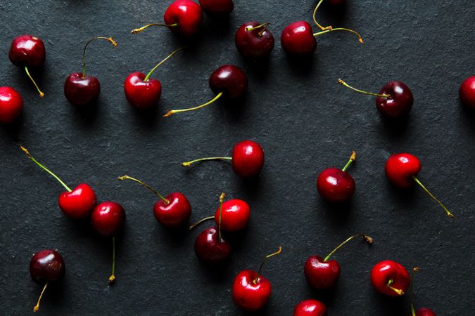 Shiny ripe red cherries on dark background