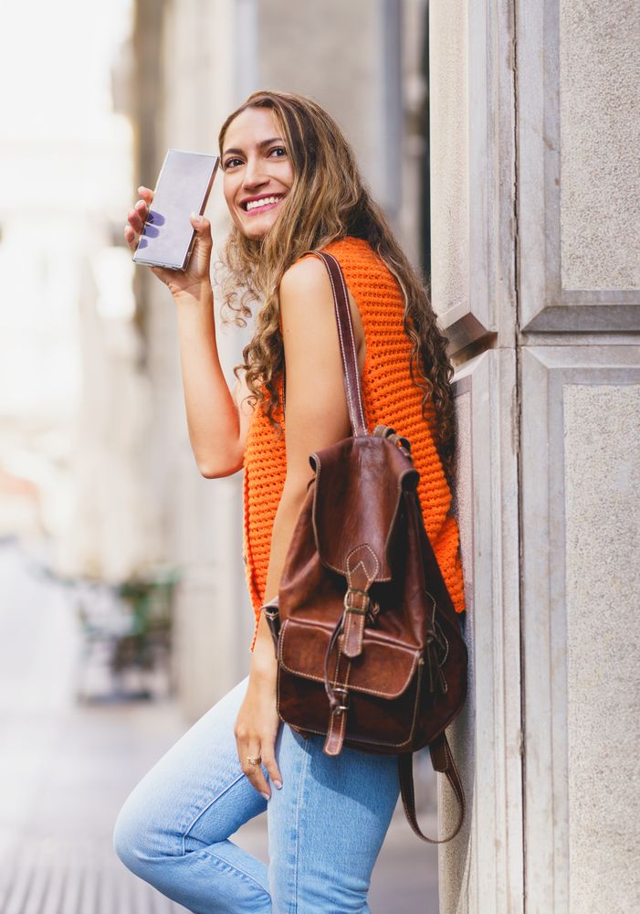 Woman walking with leather bag outside