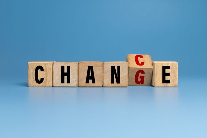 flip wooden blocks with change and chance words isolated on blue background