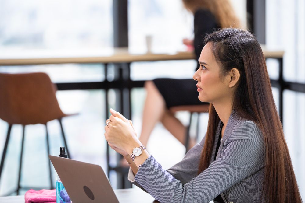 Corporate female worker in office with computer laptop