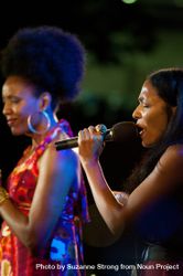 Los Angeles, CA, USA - July 12, 2012: Woman passionately singing with microphone 0VwpY5