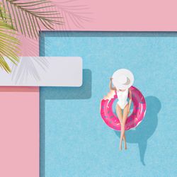 Barbie-like doll in donut ring in pool