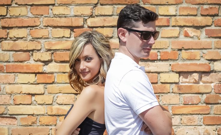 Couple portrait in front of brick wall