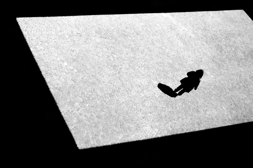 Woman walking in sunny shadow