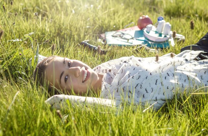 young student lying in the park