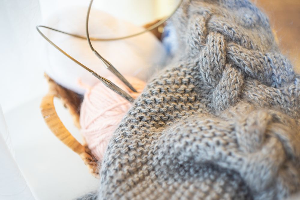 Close up of vintage knitting sweeter on a chair in light room