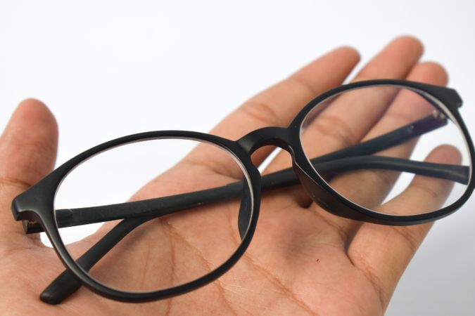 Spectacles held in palm of hand