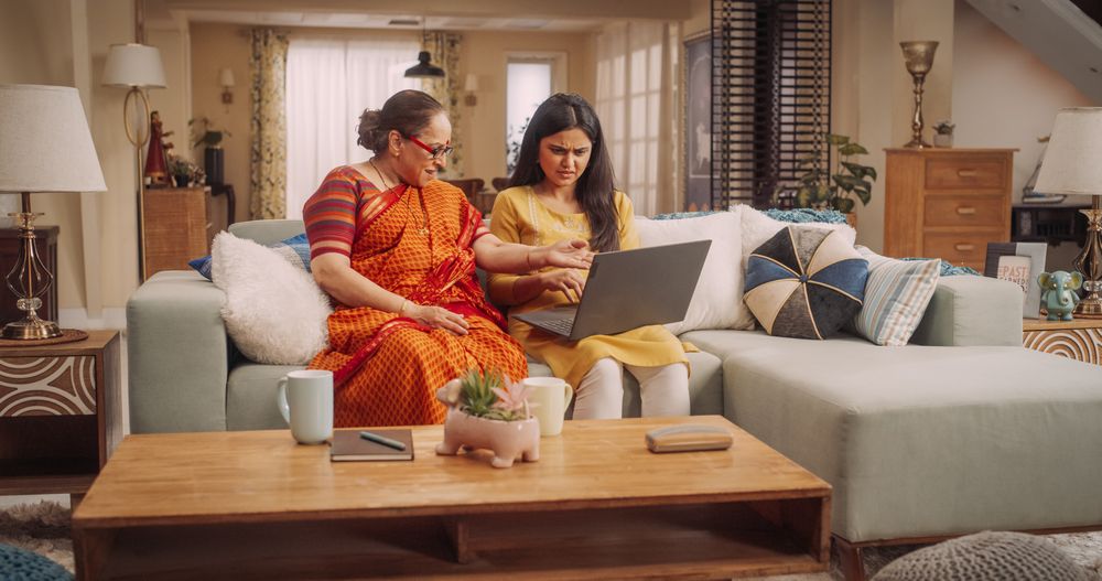 Indian Mother and Daughter Use Laptop at Home