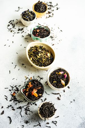 Loose leaf tea varieties on marble background