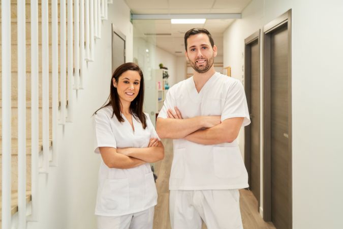 portrait of two physiotherapists in their clinic looking at the