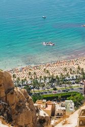 Stunning turquoise water and seashore with people palms boats