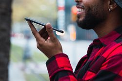 Anonymous Black man talking on smartphone on street