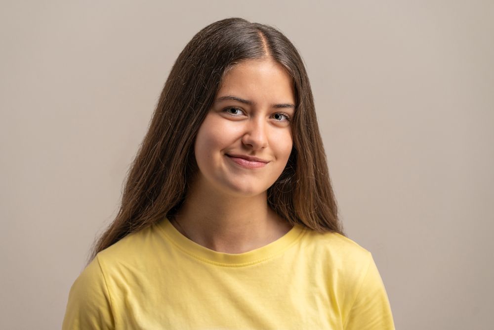 Natural close-up portrait of a friendly and authentic teenage girl.