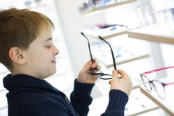Young boy trying on glasses