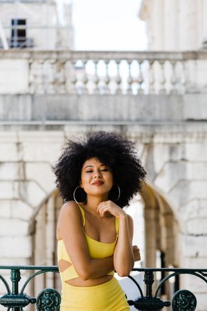 Stylish female leaning on railing outdoors