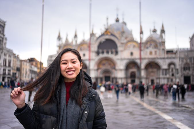 Traveler exploring city with historical buildings and waterlines