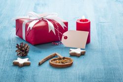 Blank gift tag on present wrapped red paper