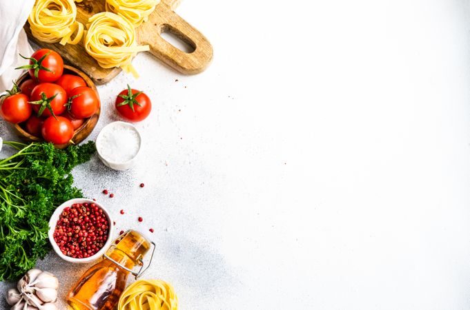 Top view of raw Fettuccine pasta and fresh vegetables on counter with copy space