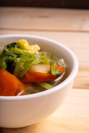 A bowl of soup with vegetables in it