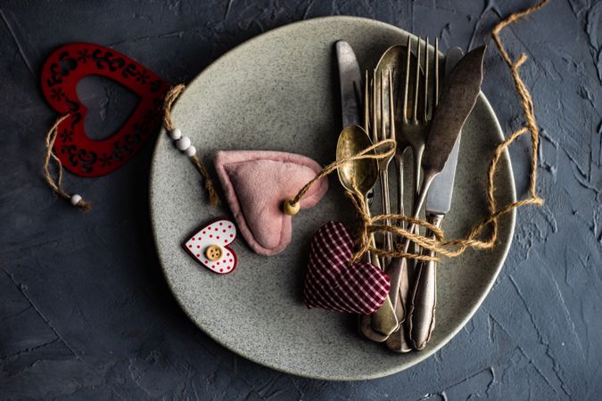 St. Valentine day table setting with felt hearts, string and cutlery