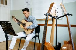 Man playing guitar in studio