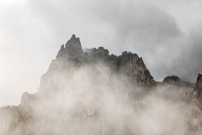 Big mountains near pine forest on cloudy weather