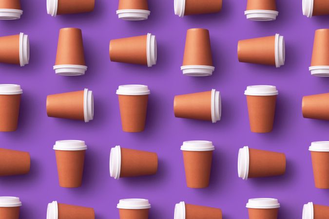 Pattern of disposable coffee cups on purple background