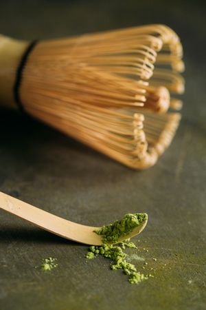 Green matcha tea powder and bamboo whisk