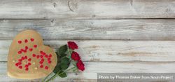 Valentine’s Day with heart of gold and rose flowers on aged wood 5o2Xm0