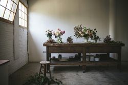 Bunches of flowers in vases on table